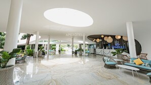 A spacious lobby with a high ceiling, marble flooring, and modern furniture. - Cozy Seaside Studio with Balcony Scenic Ocean View (Lapu-Lapy City)