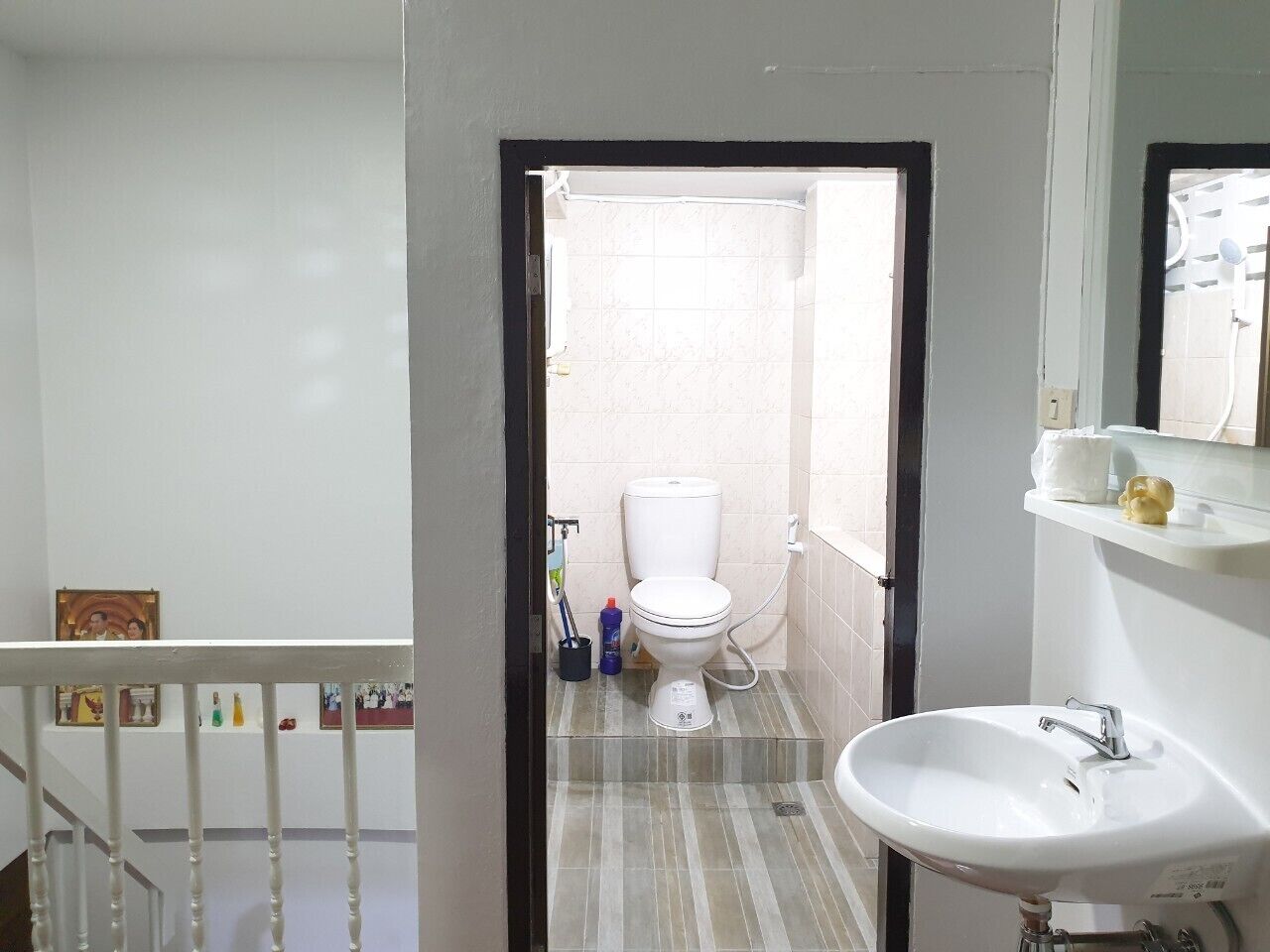 A bathroom with a toilet, sink, and shower.