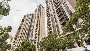 A high-rise building with multiple balconies and a modern architectural design.