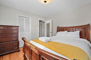 A bedroom with a wooden bed, a dresser, and a door. - Family friendly home, sleeps 8, close to DC attractions.
New kitchen.  (Alexandria)