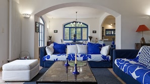 A living room with a sofa set, a coffee table, and a fireplace.