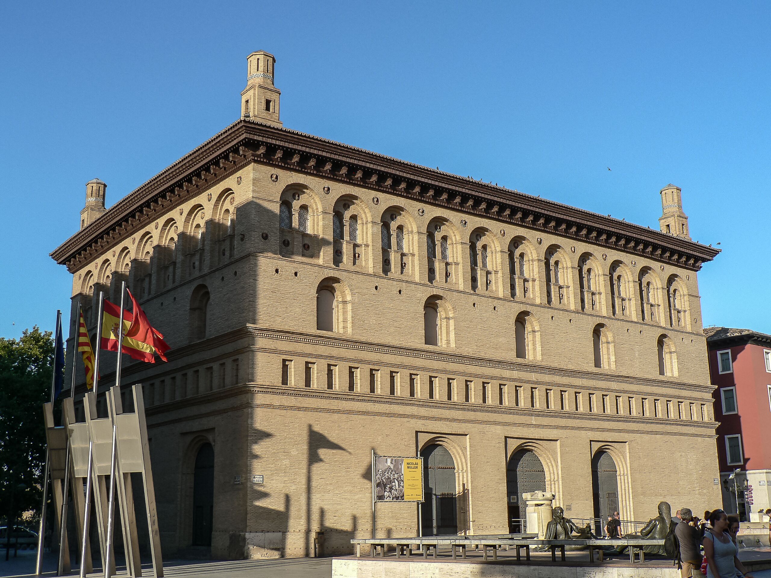 A historic building with a symmetrical facade, arched windows, and a central tower.