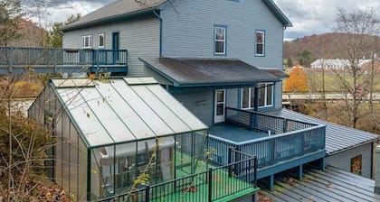 Dog-friendly, riverfront home with games galore, pool, & mountain view