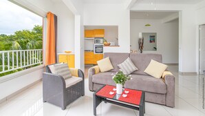 A modern living room with a sofa, two armchairs, a coffee table, and a balcony with curtains.
