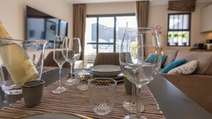 A dining area with a table set for a meal, including wine glasses and a bottle of wine. - AM LUXURY HOME IN PUERTO RICO (Mogán)