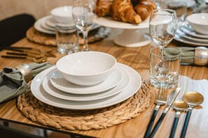 A table set with white plates, bowls, glasses, and cutlery, indicating a meal setup. - Central London, 5 Min 2 Angel Tube Station (London)