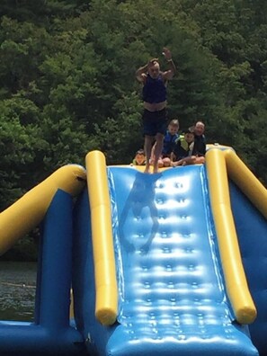 A water slide with inflatable sides and a blue slide surface.