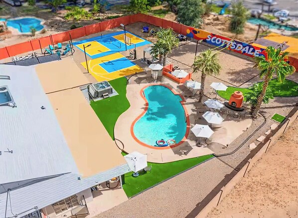 A pool area with a blue and yellow play zone, a small pool, and palm trees. - Heated Pool, Volleyball, Pickleball, Hot Tub! Oasis Resort (Scottsdale)