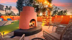 An outdoor patio with a brick oven, wicker chairs, and a small pool area. - Heated Pool, Volleyball, Pickleball, Hot Tub! Oasis Resort (Scottsdale)