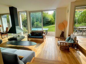 Smart-tv, eldstad, ett bordtennisbord och datorskärmar