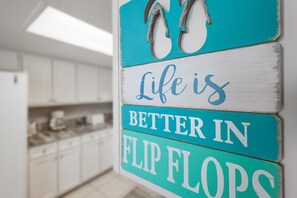A kitchen with white cabinets and a countertop.