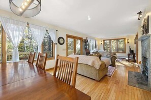 Relax in this inviting space with a comfortable sofa, dining table, and fireplace.