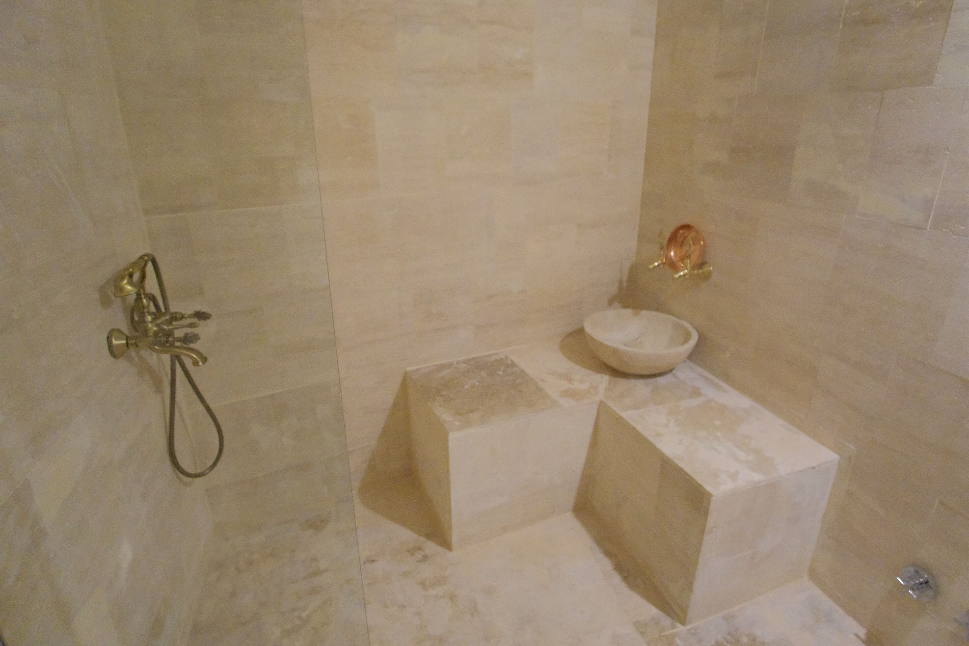 A bathroom with a shower, a sink, and a toilet.