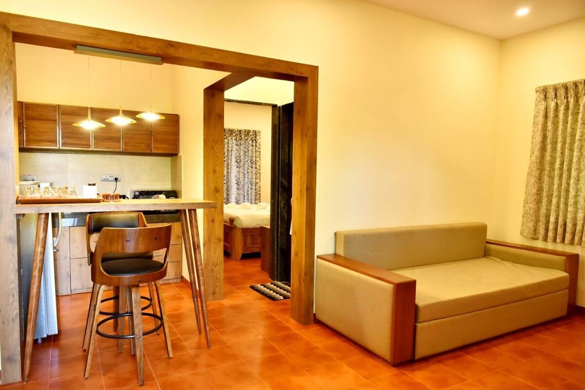 A compact living space with a kitchenette, a sofa, and a dining area.