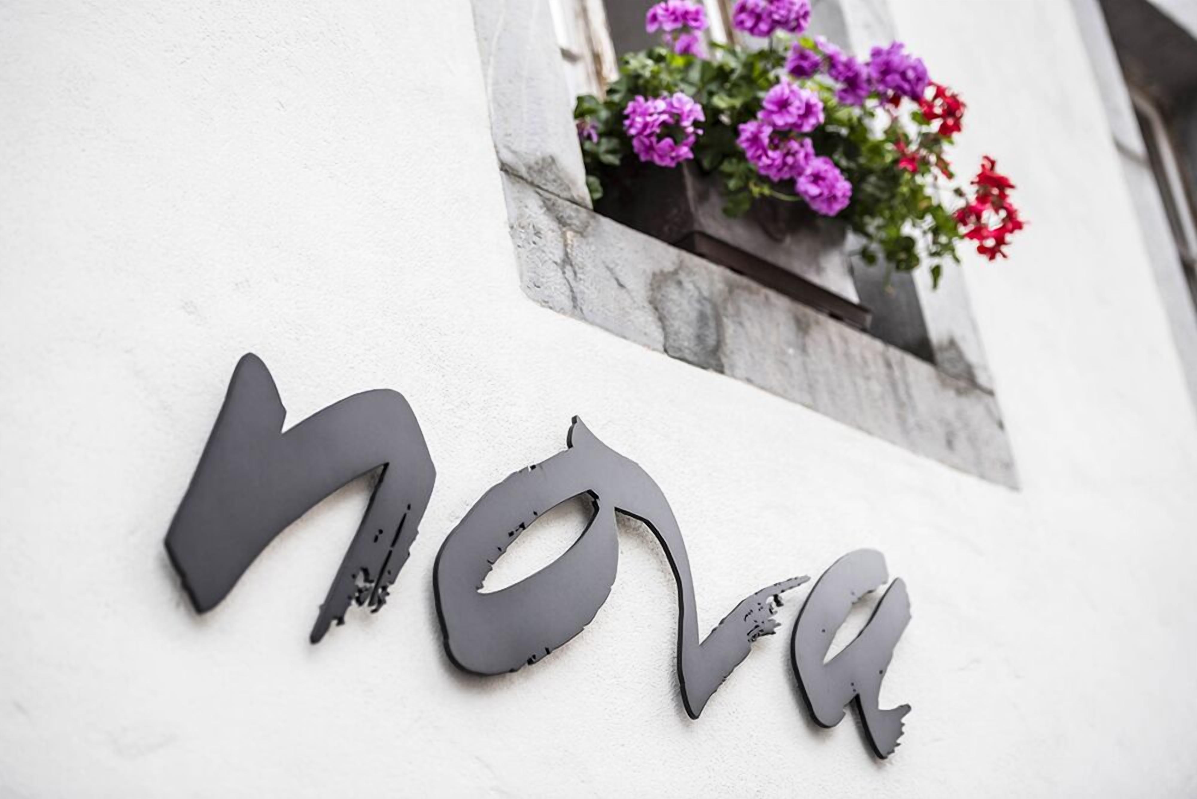 A building facade with the word "nova" in large, dark letters.