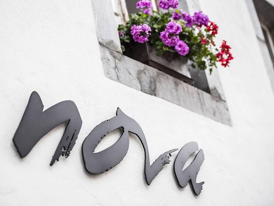 A building facade with the word "nova" in large, dark letters.