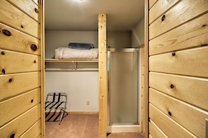 A compact room with a bunk bed, a small shelf, and a shower stall. - Trego Cabin w/ Mtn Views, Easy Access to Lake (Trego)