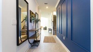 A hallway with a mirror, a bench, and a rug. - Last Minute Disney! Private Pool, Hot Tub, Game Room & Themed Bedrooms. Book Now! #104317 (Orlando)