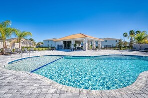 A swimming pool with a tiled deck, lounge chairs, and a covered patio area. - Last Minute Disney Getaway! Private Pool & Themed Bedrooms. Book Now! #81917 (Orlando)