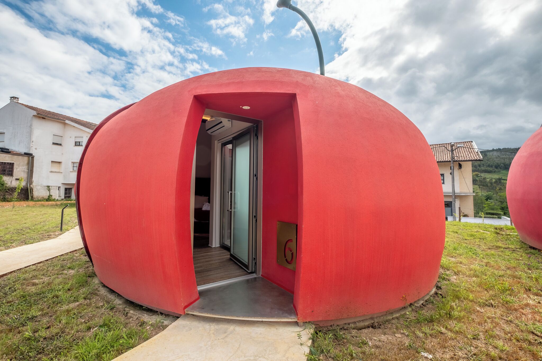 A spherical structure with a door leading inside.
