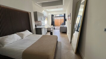 Luxury Studio Suite | Living area | 40-inch Smart TV with digital channels