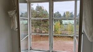 A room with a large window, curtains, and a towel hanging on the wall. - Beautiful 2 Bed Apartment Sauna Facility in Kotka (Kotka)