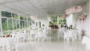 A spacious indoor venue with white tables and chairs, large windows, and a ceiling with a grid pattern. - Hotel mirador San jose (Santa Rosa de Cabal)
