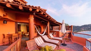 A terrace with wooden furniture, a hammock, and a view of the sea. - March Break Mexico Getaway
2 Bedroom Beach front Vacation Home
Sleeps 6 (Zihautanejo)