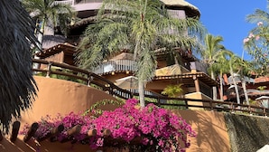 A resort building with a thatched roof, palm trees, and pink bougainvillea flowers. - March Break Mexico Getaway
2 Bedroom Beach front Vacation Home
Sleeps 6 (Zihautanejo)