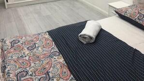 A bedroom with a large mirror, a bed with patterned bedding, a bedside table, and a wardrobe. - 2 Bed-1 Bath-sleeps 4-parking-pets (High Wycombe)