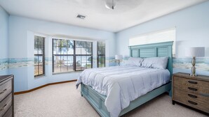 A bedroom with a bed, dresser, and window with blinds. - Private Lake View House Rental close to wonderful Big Bass Grill restaurant  (Lake Panasoffkee)