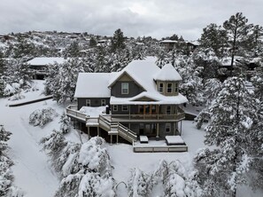 A large two-story house with a balcony and a covered porch area.