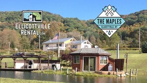 A riverside property with a small dock, a house, and a cabin.