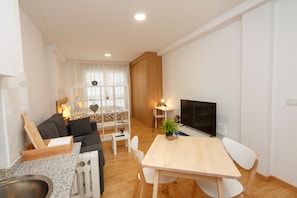 Comfort Apartment | Living area | 55-inch Smart TV with cable channels, MP3 dock