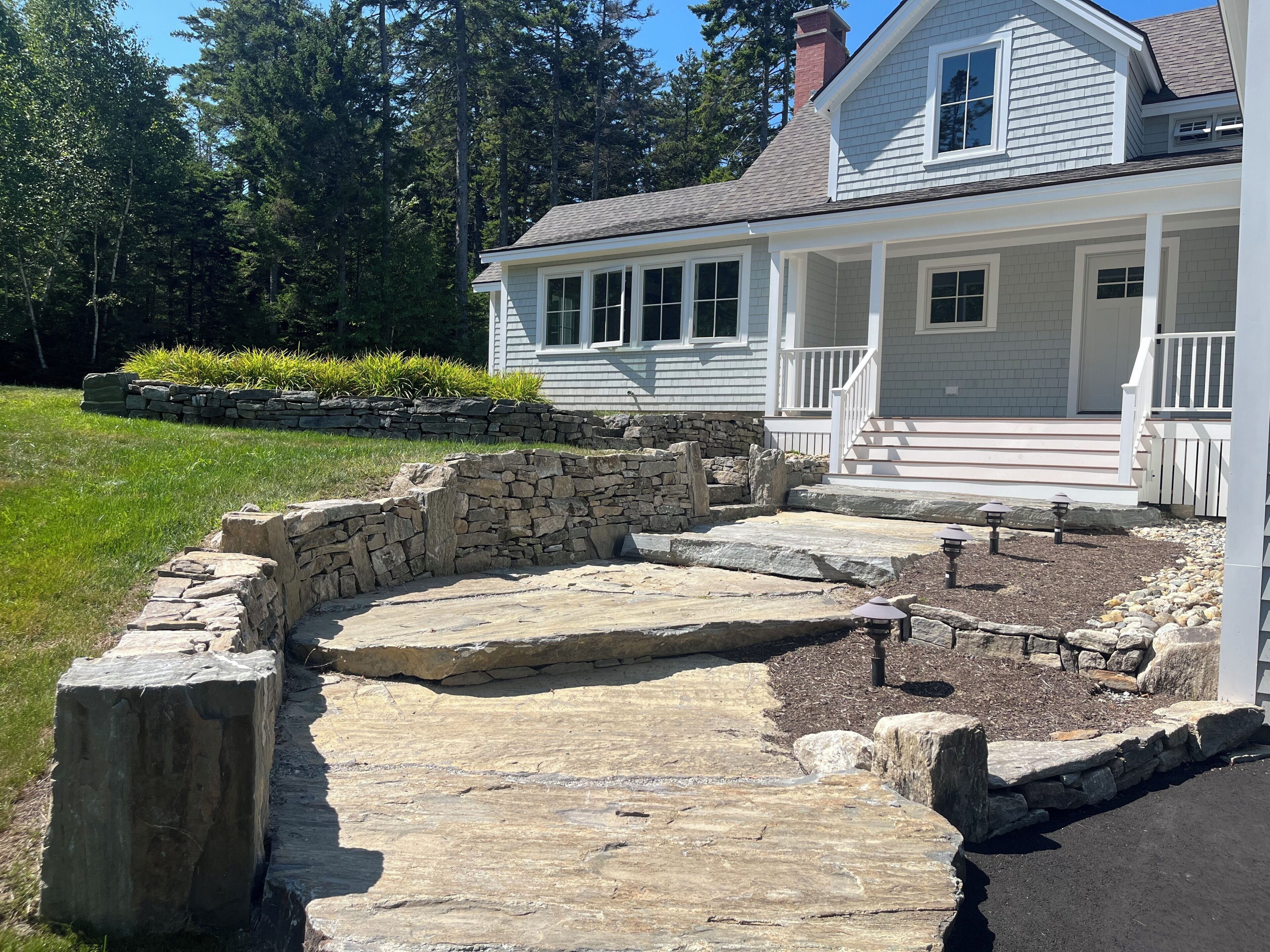 A house with a stone pathway leading to a porch.