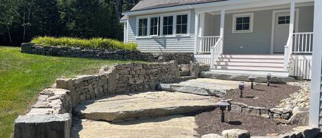 A house with a stone pathway leading to a porch.