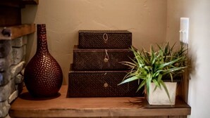 A wooden shelf with a decorative vase, a set of drawers, and a potted plant. - Mountain Rustic Perfection in Prime Locale (Park City)