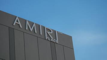 A building with the sign "AMIRI PLACE" on its facade.