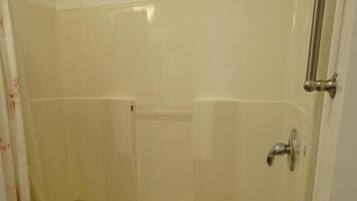 A bathroom with a bathtub, a shower, and a toilet.