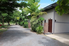 A pathway leading to a building with a door marked '4' and a sign indicating a bathroom.