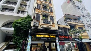 A multi-story building with a travel booking office on the ground floor. - Hoang Duong Hotel by Bay Luxury (Hanoi)