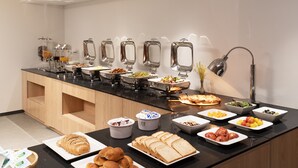 A buffet setup with various food items and beverages.