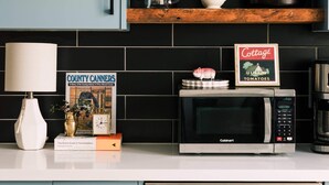 Une cuisine équipée d’un four à micro-ondes, d’une machine à café et d’un livre intitulé « County Canners ».