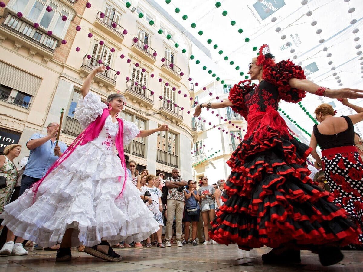 A street performance with dancers in traditional dresses.