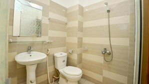 A bathroom with a sink, toilet, and shower. - Ha Noi Vang Hotel by Bay Luxury (Hanoi)