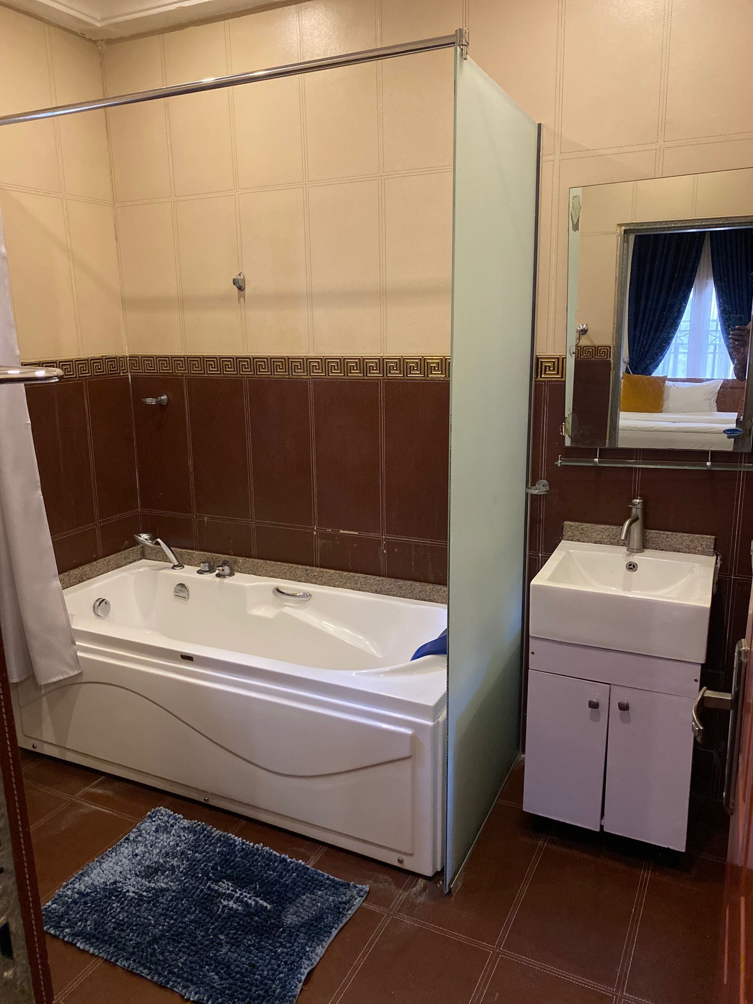 Een badkamer met een bad, een wastafel en een spiegel.