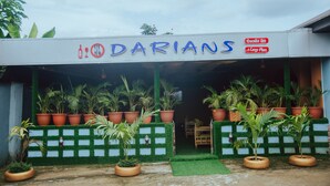 A storefront named "DARIANS" with a sign indicating "Executive Bar & Cezve Place".