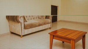 A room with a beige sofa and a wooden coffee table.