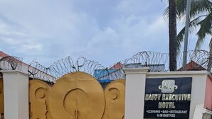A hotel entrance with a large decorative gate, a sign for Happy Executive Hotel, and a barbed wire fence in the background. - Haffy Executive Hotels and Suite (Uyo)