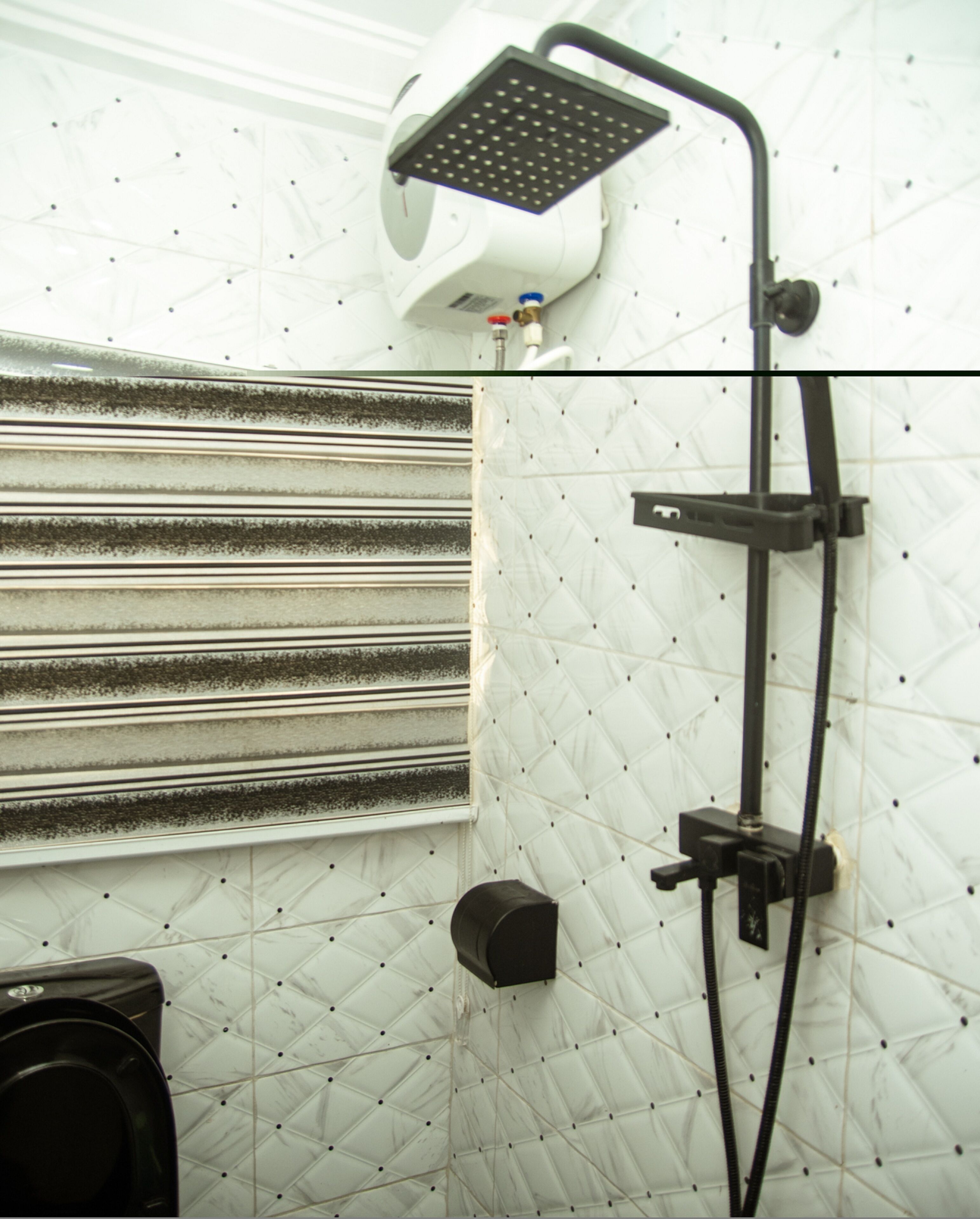 A shower with a handheld head and a wall-mounted panel, a towel rack, and a toilet.